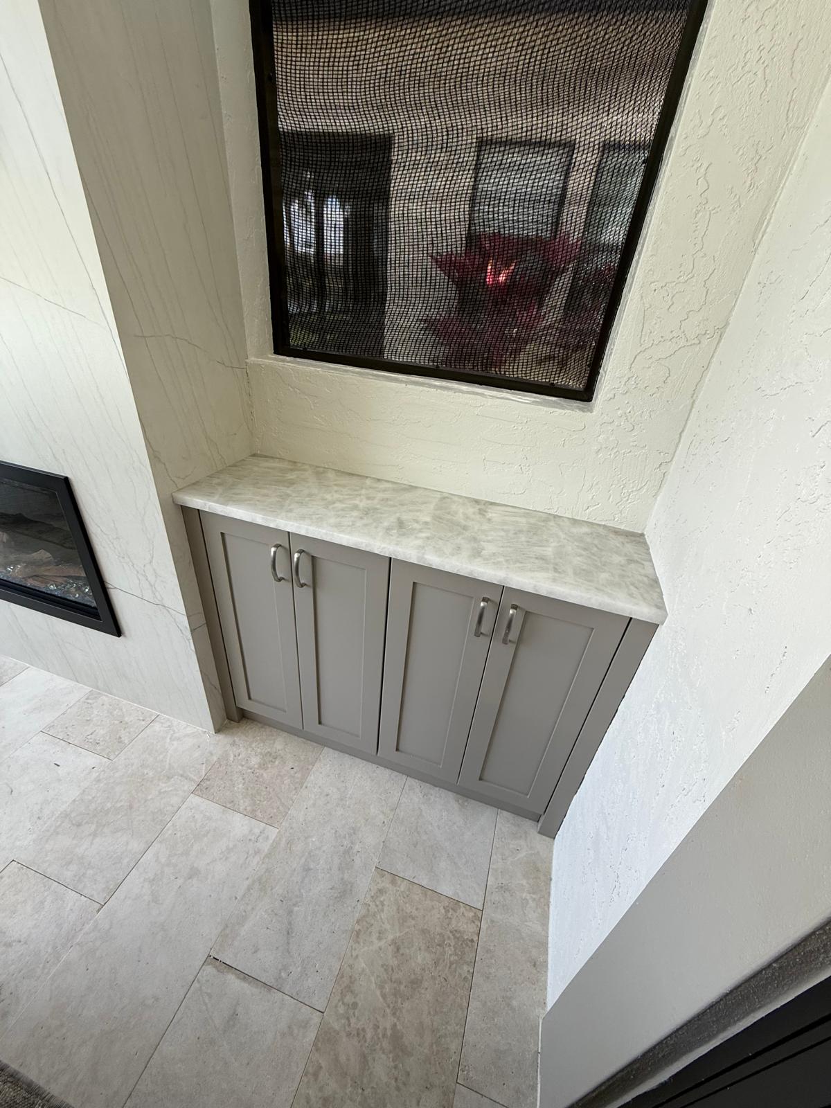 Tuscan cabinet with Shaker door style and marble countertop