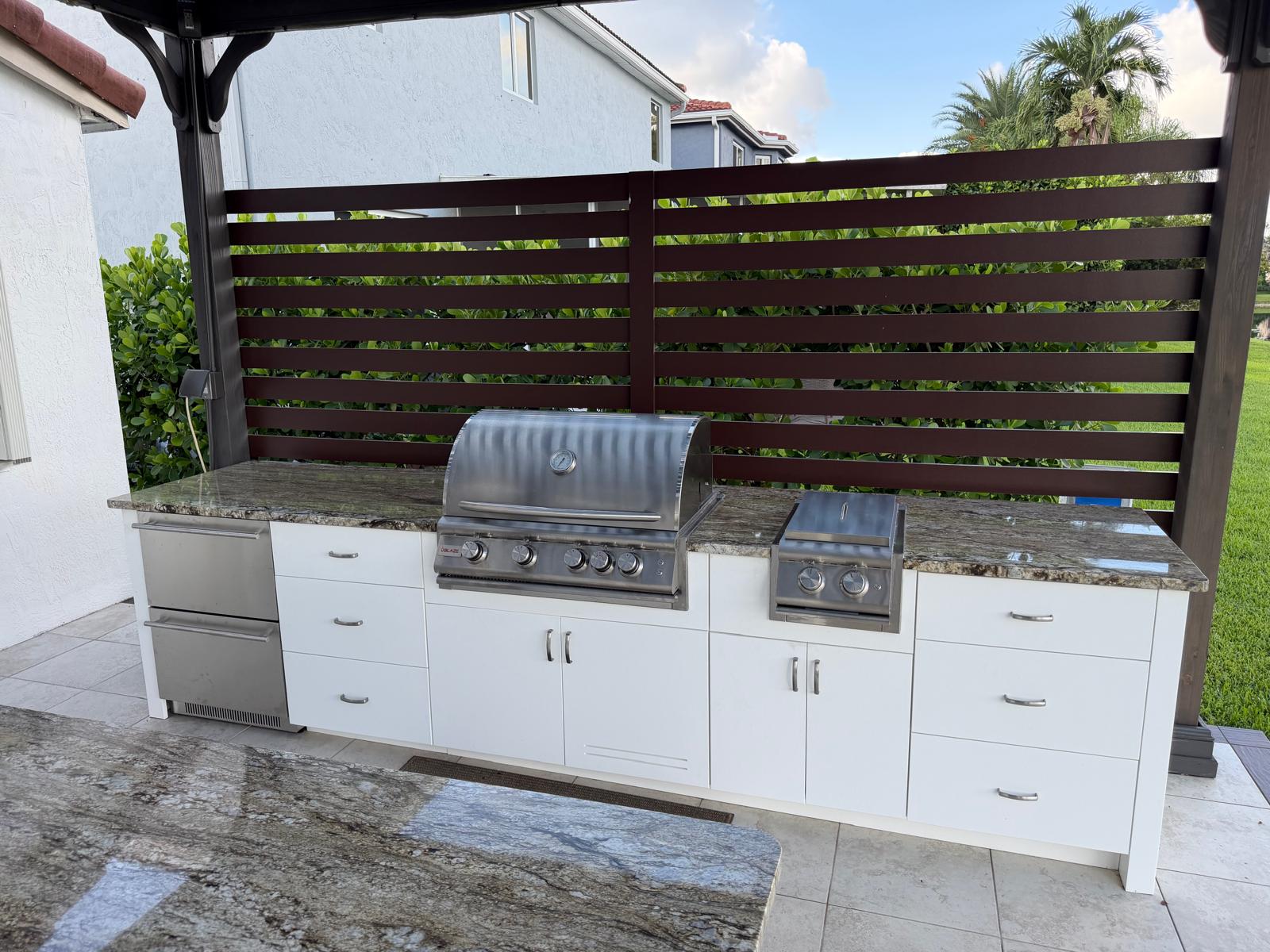 White outdoor kitchen with Flat Panel door style and granite countertop
